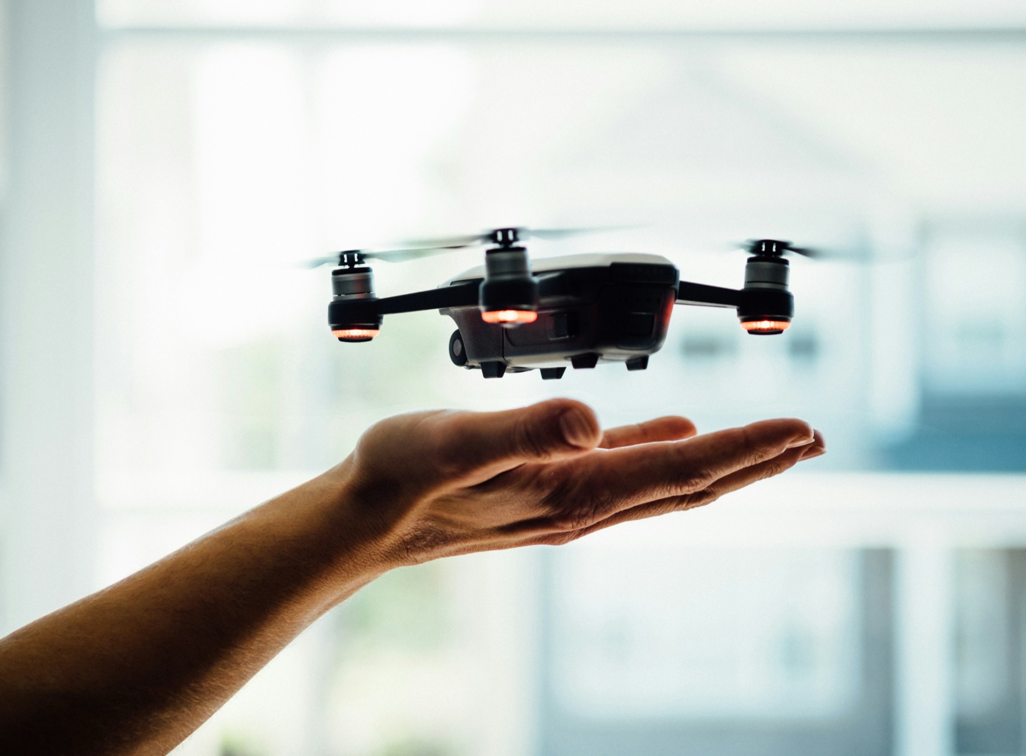 Drone hovering above an open hand