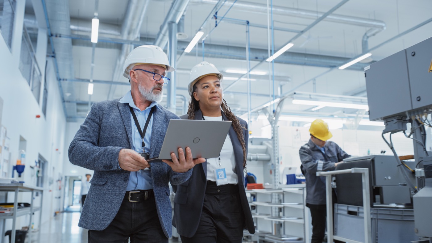 Engineers reviewing plans on the factory floor